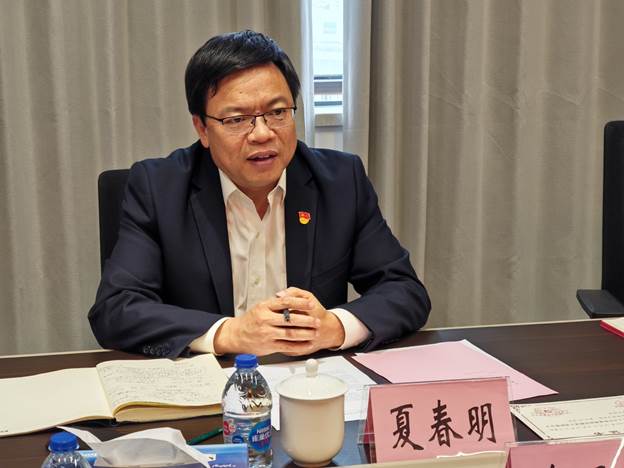 A person sitting at a desk
Description automatically generated